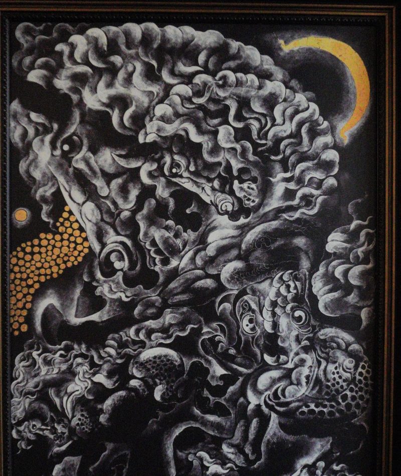 Baan Dam: The Black House Museum A monochromatic abstract painting featuring swirling forms and intricate details, accented by orange dots and a crescent moon in the background.