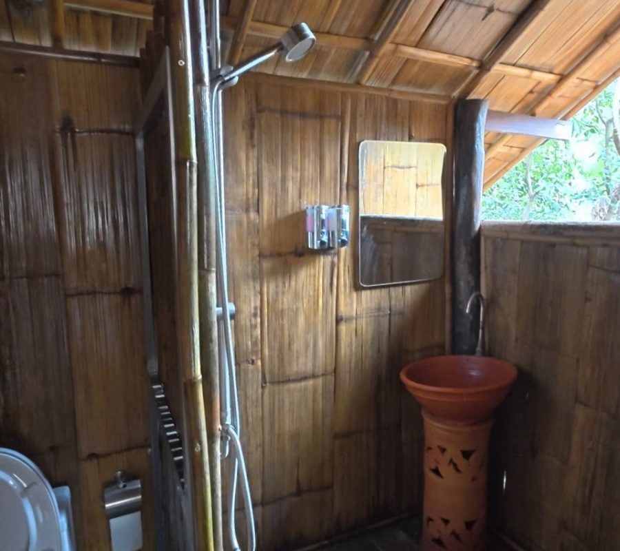 Overnight Stay At Chai Lai Orchid Elephant Sanctuary in Thailand A natural wood bathroom featuring a bamboo shower, ceramic sink, and eco-friendly decor, evoking a tranquil, outdoor ambiance.