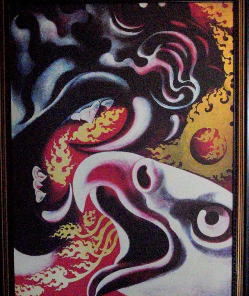 Baan Dam: The Black House Museum An abstract painting featuring swirling flames, eyes, and cosmic elements, blending vibrant colors and surreal forms.