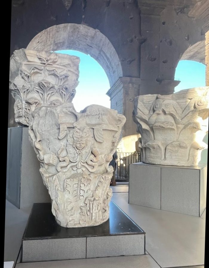 Intricate carvings of ancient Roman column capitals showcasing floral and mythological designs.