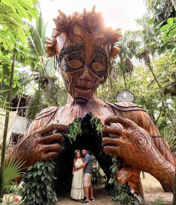 two people at the ven a la luz sculpture in tulum