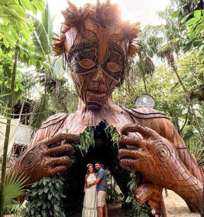 two people at the ven a la luz sculpture in tulum